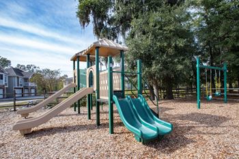 A playground with a play set and slides